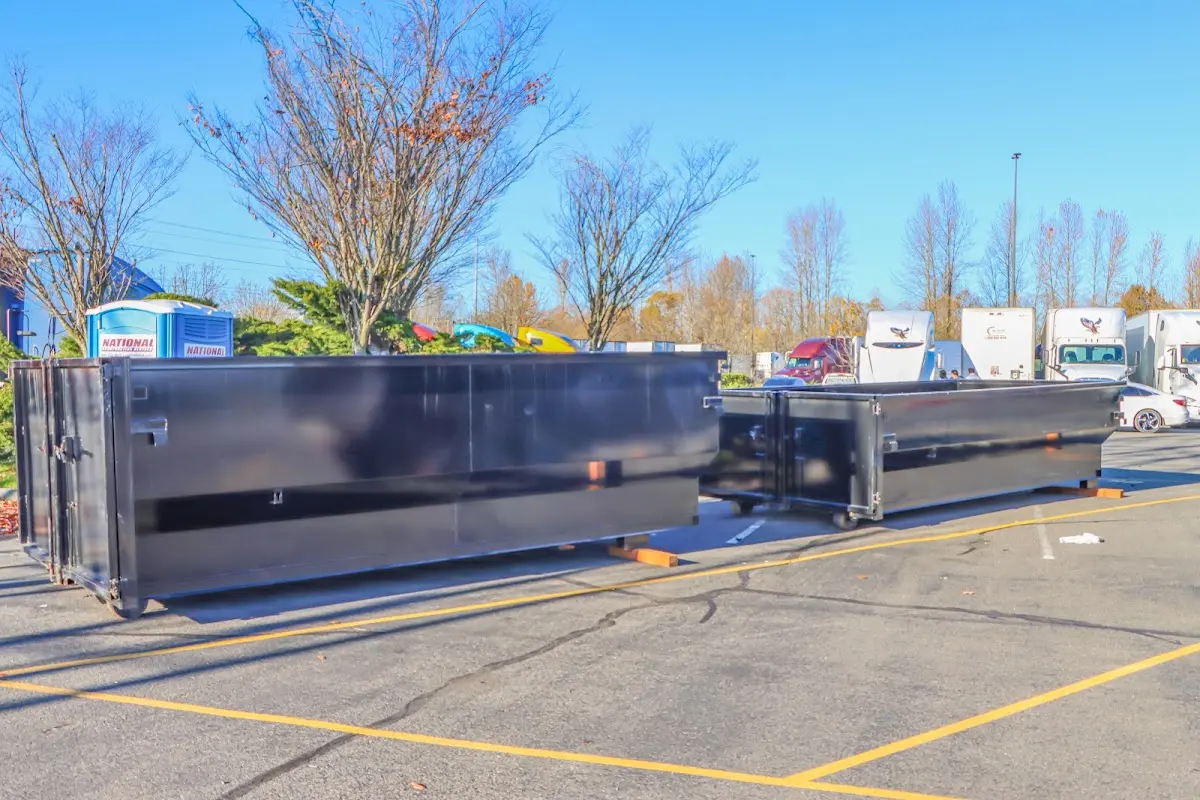 Professional dumpster rental service with roll-off container on residential driveway in Forestbrook